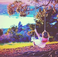 a woman swinging on a swing