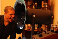 a man is standing in front of a large speaker