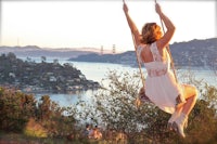 a woman swinging on a swing